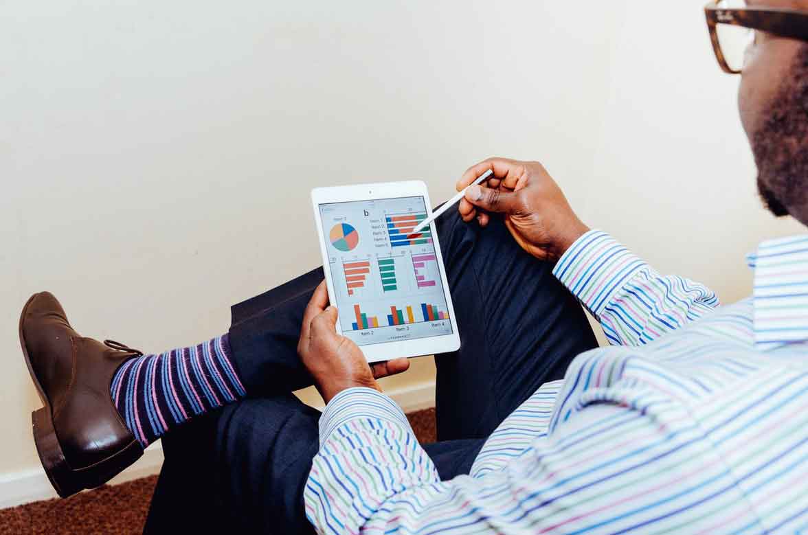 Person looking at charts on a tablet